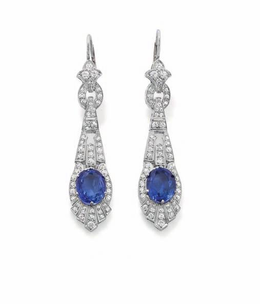 231 231 A Pair of Art Deco Sapphire and Diamond Ear Pendants Each designed as an openwork, articulated pendant drop, set with an oval-cut sapphire, weighing approximately 8.