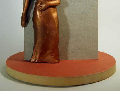 The female figure, suggestive of Mother Africa, stands on the side of the slab bearing the name