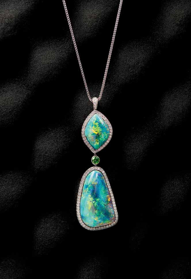 22 47 An opal and diamond set pendant necklace the pendant set with two large graduated opals, each in a border pavé set with small round brilliant cut diamonds, the link collet set with a small