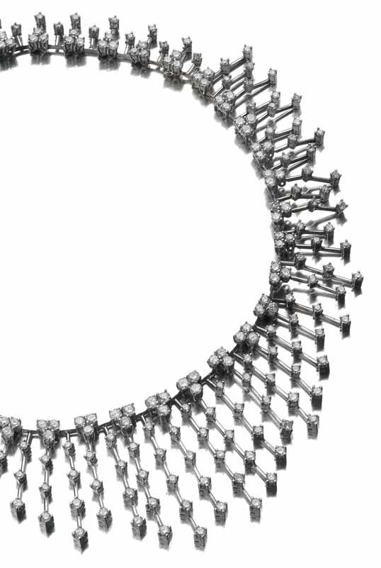 32 71 A diamond fringe necklace of graduated design, fringed by knife bars, claw set throughout with graduated round brilliant cut diamonds