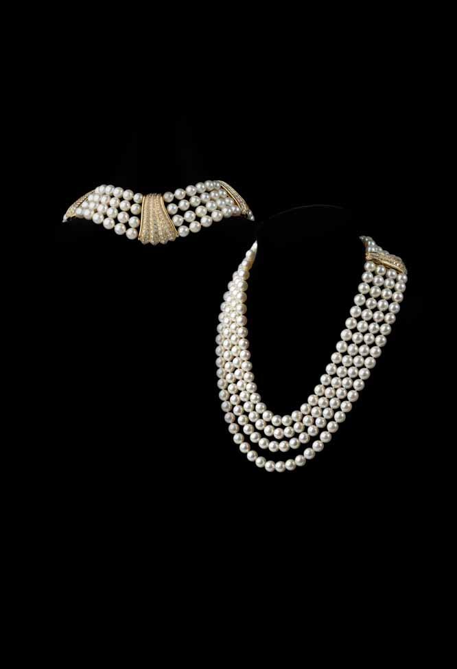 35 78 A cultured pearl and diamond set necklace composed of four rows of uniform cultured pearls, set with two