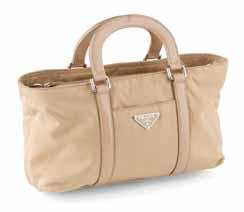 PRADA A leather and nylon handbag modelled in tan nylon with leather straps, the body with slip pocket and internal zip pocket, detachable shoulder strap
