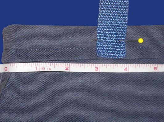 One end of the first strap should be placed 3 inches in from the left side seam, while the other end should be 3 inches in from the right side seam. You will need to pin the strap in this location.