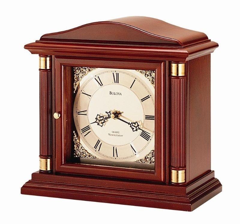 Solid wood case, walnut finish. Metal dial with chapter ring and raised corner ornaments.