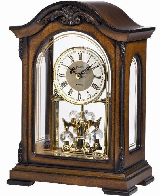 B1845 DURANT. Solid wood case, Old World walnut finish. Decorative carved accents. Metal dial. Decorative screened glass front and side panels. Removable clear acrylic back panel.