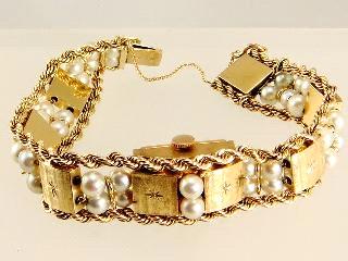 498 Long single strand of cultured pearls, diamond set clasp.