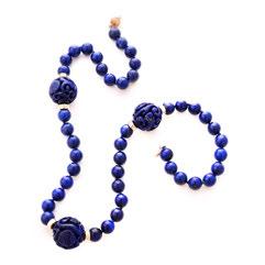 37 Lapis Lazuli, 14k Yellow Gold Necklace. Featuring three carved round lapis lazuli beads measuring approximately 20.