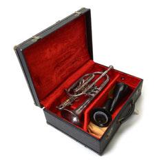 493 Capri by Getzen Trumpet. Nickleplate Trumpet, with Mother of Pearl Buttons, hard Fitted Case, K & M and Bach Mutes, 7C Mouthpiece. {Dimensions: l 14 1/4 x W 7 inches.} 493 Sold $180.