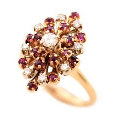 Featuring round-cut rubies weighing a total of approximately 0.50 cttw., set in a 14k yellow gold flower motif cluster mounting.