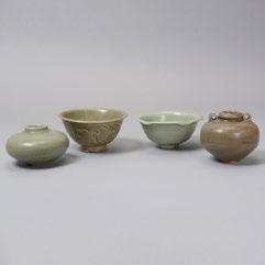 198 Four Celadon Glazed Ceramics Song Dynasty Comprising two small bowls each with carved decoration, and two small crackle glazed jars. {Widest: 4 5/8 inches (11.