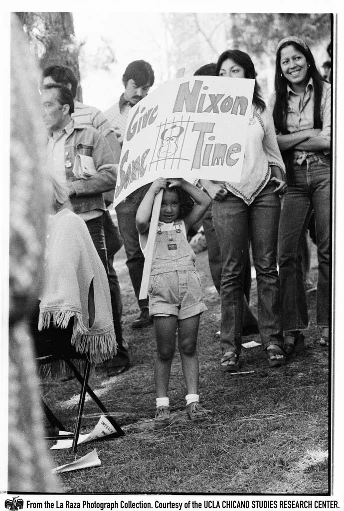 Girl holds "Give Nixon Some Time" sign at "Dump Nixon" march from Echo Park to MacArthur Park