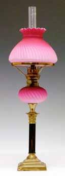 glass globular shade, 61cm high inclusive of shade 120-180 (+ 24% BP*) Lot 462 Victorian oil lamp having a small pink satin glass reservoir with wrythened decoration, standing on