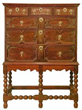 long drawers having brass handles and escutcheons and typical geometric mouldings, the base standing on bobbin turned