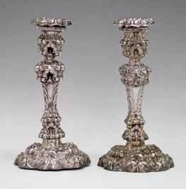 Lot 554 Lot 554 Pair of Victorian silver rococo style candlesticks, having allover embossed stylised foliate and scroll decoration, makers