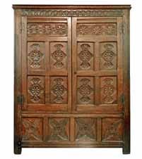 Lot 31 Lot 31 Antique oak two door cupboard having a moulded cornice, carved arcaded frieze below, the panelled doors with carved stylised foliate
