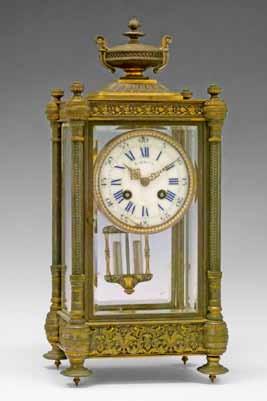 gong, 43cm high 400-600 (+ 24% BP*) Lot 107 Late 19th/early 20th Century French brass cased four glass mantel clock, surmounted with a classical urn, a pillar to each corner, united at the