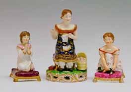 Lot 279 Lot 279 19th Century Derby porcelain figure depicting a young woman seated, sewing, a book on her lap and a baby in a cradle beside her, 14cm high, together with two Bloor Derby figures, the