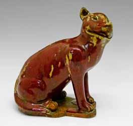 Lot 325 Lot 325 Chinese sang de boeuf glazed pottery figure of a seated dog having light brown patches, 17.