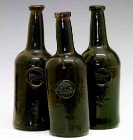 Lot 420 Three late 18th/early 19th Century green glass wine bottles, each with circular applied seal with the initials H.H.C., 21.