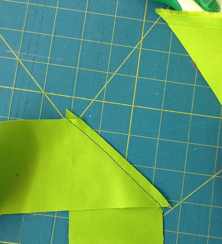 Match this center to the center pleat, matching the sash edge to the top edge of the skirt.