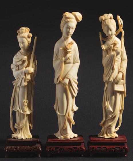 150-250 732 732 A pair of Chinese carved ivory figures of women in traditional robes holding