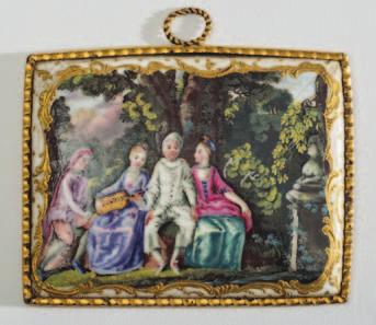 804 804 A late 18th century English enamel rectangular plaque decorated with four entertainers, possibly from the Commedia dell Arte, seated in a formal garden within a gilt scrolled cartouche, 8.