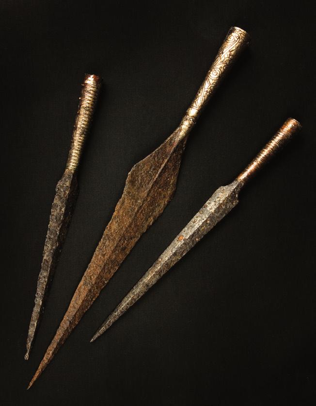 A 7th-century Viking helmet. Upper: Weapons were also works of art, such as these 7th-century spearheads with intricate patterns.