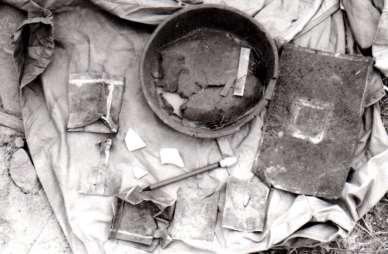 Figure 8 surface artifacts documented in 1984 including opium cans and solder patched metal, photo from 1984 site record.