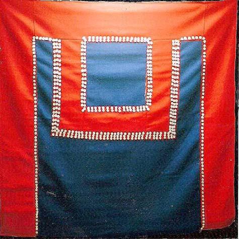 We cannot see the back of the blanket, but in the front the row of buttons is clear. There are other photographs of Chief Isaac and his button blanket, but again no examples of the back.