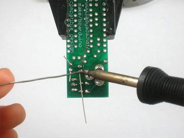 Solder in the capacitors and clip them. Next is the green 3mm LED D2.