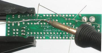 Solder and clip the leads. Place the 28 pin socket. This is to allow you to replace the microcontroller if necessary.