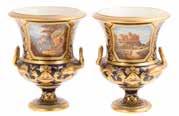 1310 Pair Derby porcelain landscape decorated urns circa 1820; campana-form urns with pair of ring handles, with cobalt ground and extensive gilt decoration, each with painted vignette, In South