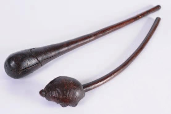 556. Two North American 18th century hardwood clubs, one of tapering form, the other of root form with carved head.
