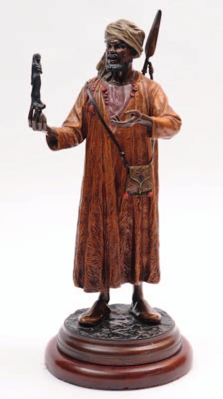 581. An Austrian cold painted bronze study of an Arab merchant holding a small Egyptian statue in his right