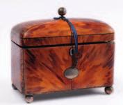 An early 19th century blonde tortoiseshell tea caddy, the rectangular cushion shaped caddy with canted corners, the hinged