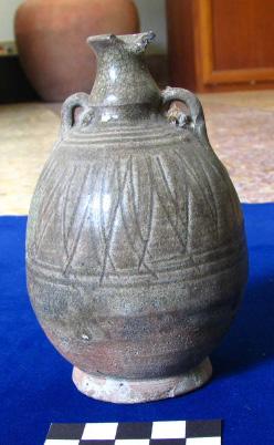 designs and horizontal parallel lines and an ovoid bottle with two handles and incised horizontal parallel