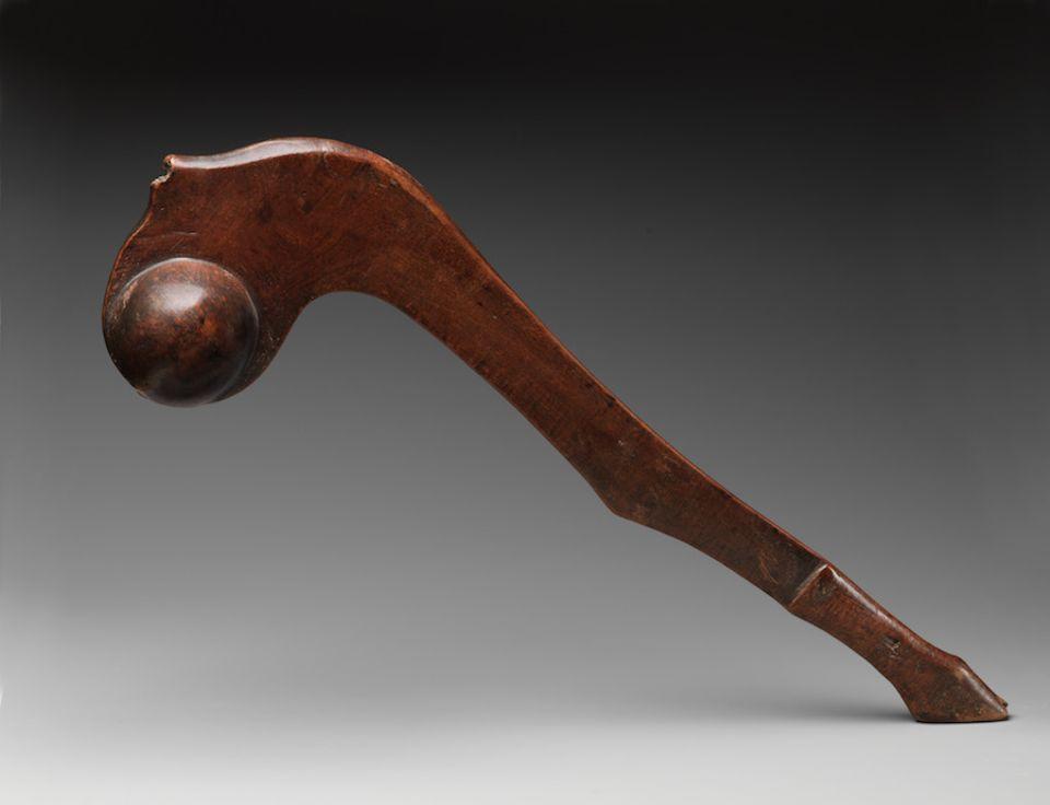 A wooden war club possibly made by an Anishinaabe or Ojibwa person around 1750, shown in the Metropolitan Museum of Art's exhibition Art of Native America: the Charles and Valerie Diker Collection