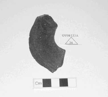 Candidate No: 63702 Miscellaneous 0V08/133A/34 a fragment of what would appear to be a spindle whorl. However, the material is shale or slate and this fragment weighs 28g.