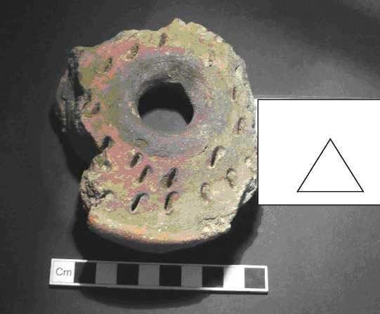 Candidate No: 63702 OV08/133A/31 Chimney Pot Top A fragment of a chimney pot top was identified. This weighed 390g. The fabric had been pierced to allow the escape of air during the firing process.