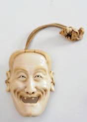long, with a cord attached to a carved ivory netsuke of a resting actor who s mask is hung around his knee, 4.5cm. long.