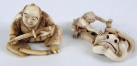 598 598 A Japanese circular carved ivory netsuke depicting an oni painting a dragon mask, 4.5cm.