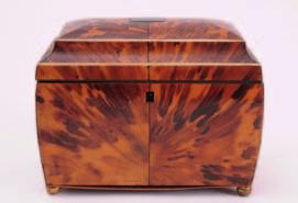 634 635 636 634 A 19th century blonde tortoiseshell tea caddy the front of double concave outline, with shallow domed hinged lid enclosing two lidded compartments, raised on squat bun feet, 20cm.