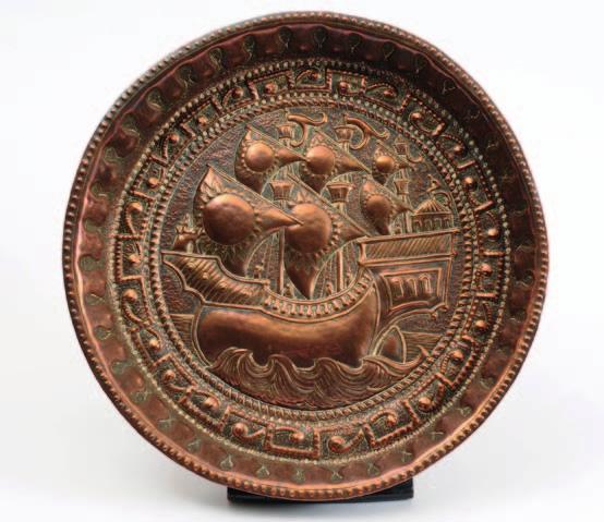 648 648 An Arts & Crafts embossed copper charger by John Pearson, the centre decorated with a three-masted galleon on a choppy sea,