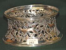 282 Large Silver Plated Dish Ring with heavily pierced frieze. 283 Large silver plated two handled Octagonal shaped Tray with raised gallery on bun feet. 284 Silver Tennis Trophy Chester 1932.
