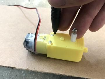Use a twist-tie or piece of solid-core wire to cinch the motor