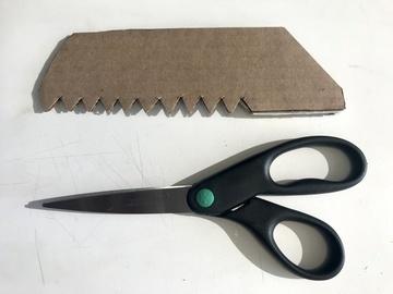 Use scissors to cut out a row of teeth along the bottom edge.