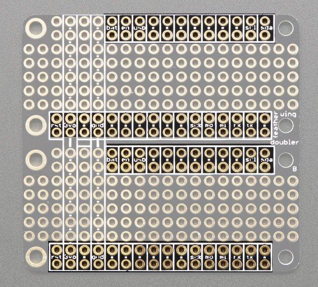 Duplicated IO Pins On the outer edges are all the pins you'd want to solder in to connect to the Feather. The inner set of pins are boxed and have small text or dots to indicate they are connected.