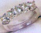 1395 A diamond cluster ring. Centre round brilliant cut diamond measuring approx 5.3mm x 5.3mm x 2.9mm deep, estimated weight 0.50 metric carat, colour & clarity assessed as I/J. VS.