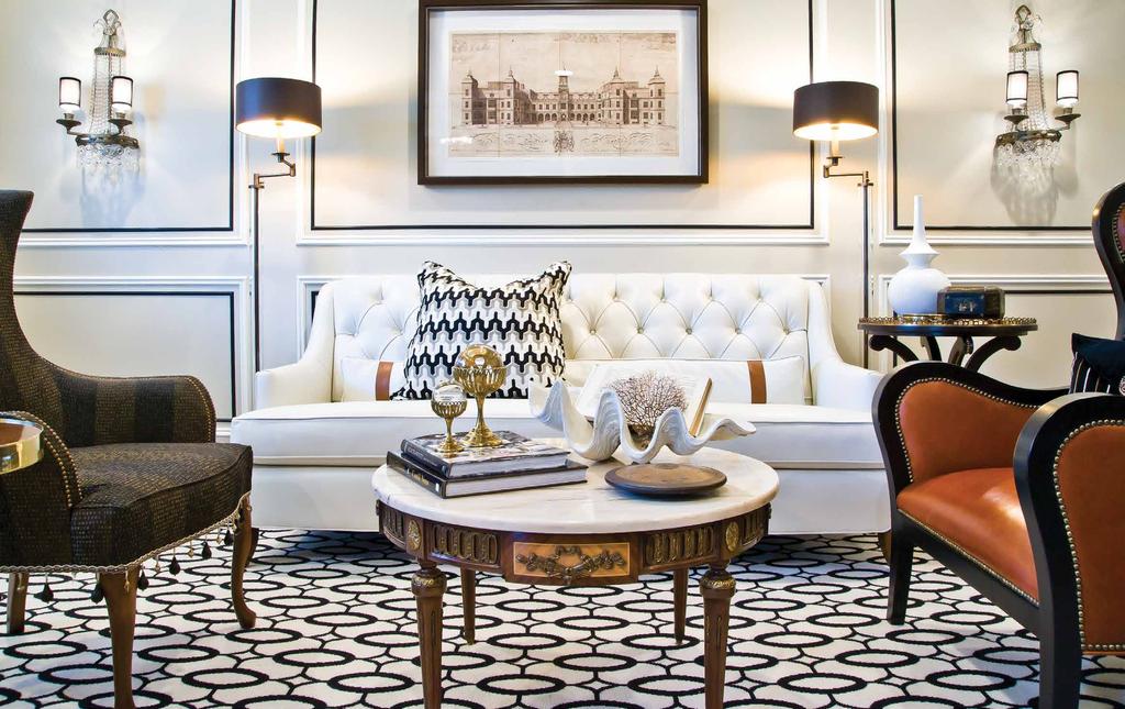 Jenkins love of black and white as evident in the contemporary rug is an interesting contrast to the antique center table and caramel-colored leather chair.