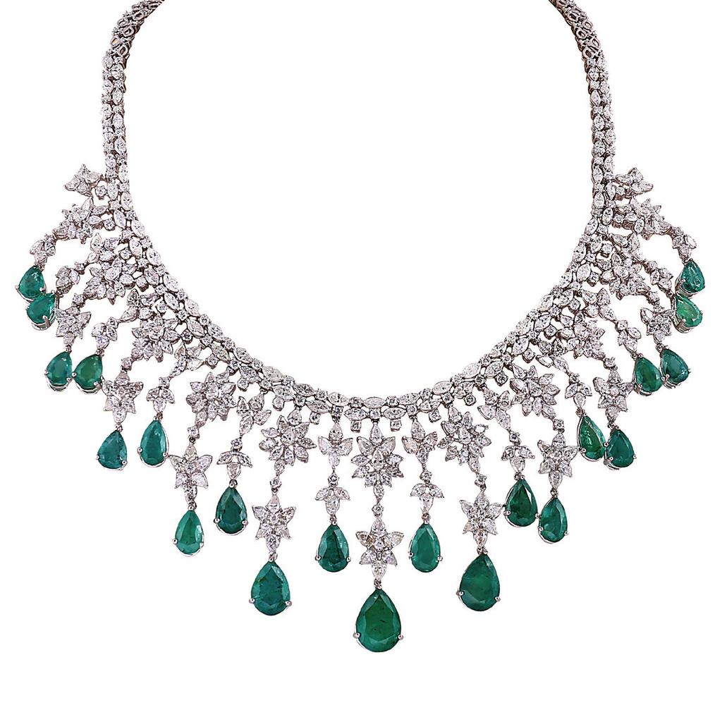 Gemfields Zambian emeralds. By Rosentiques, Mumbai Gold floral necklace fashioned Mozambican rubies.